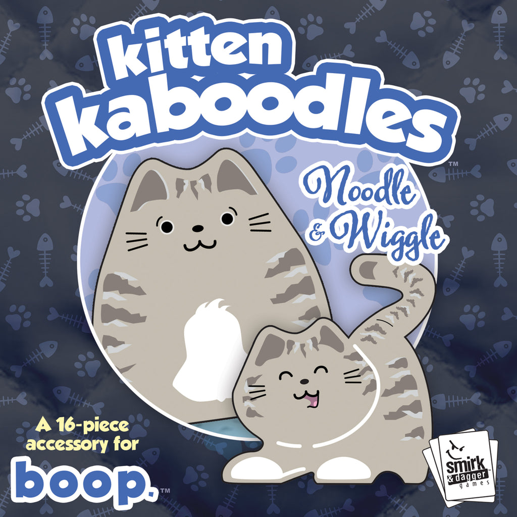 Kitten Kaboodles toy packaging with two cartoon cats on a dark blue background with paw and bone patterns.