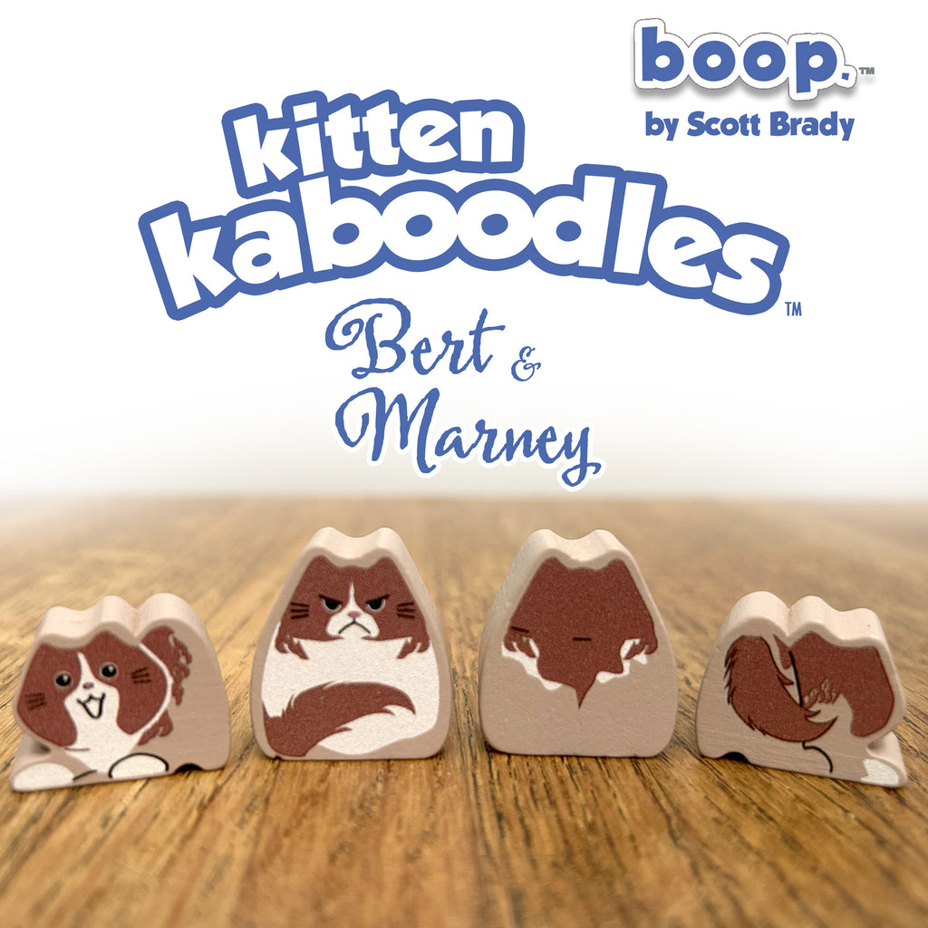 Kitten kaboodles toy figures with 'boop by Scott Brady' branding on a wooden surface.