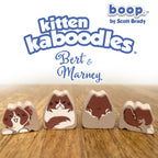 Kitten kaboodles toy figures with 'boop by Scott Brady' branding on a wooden surface.