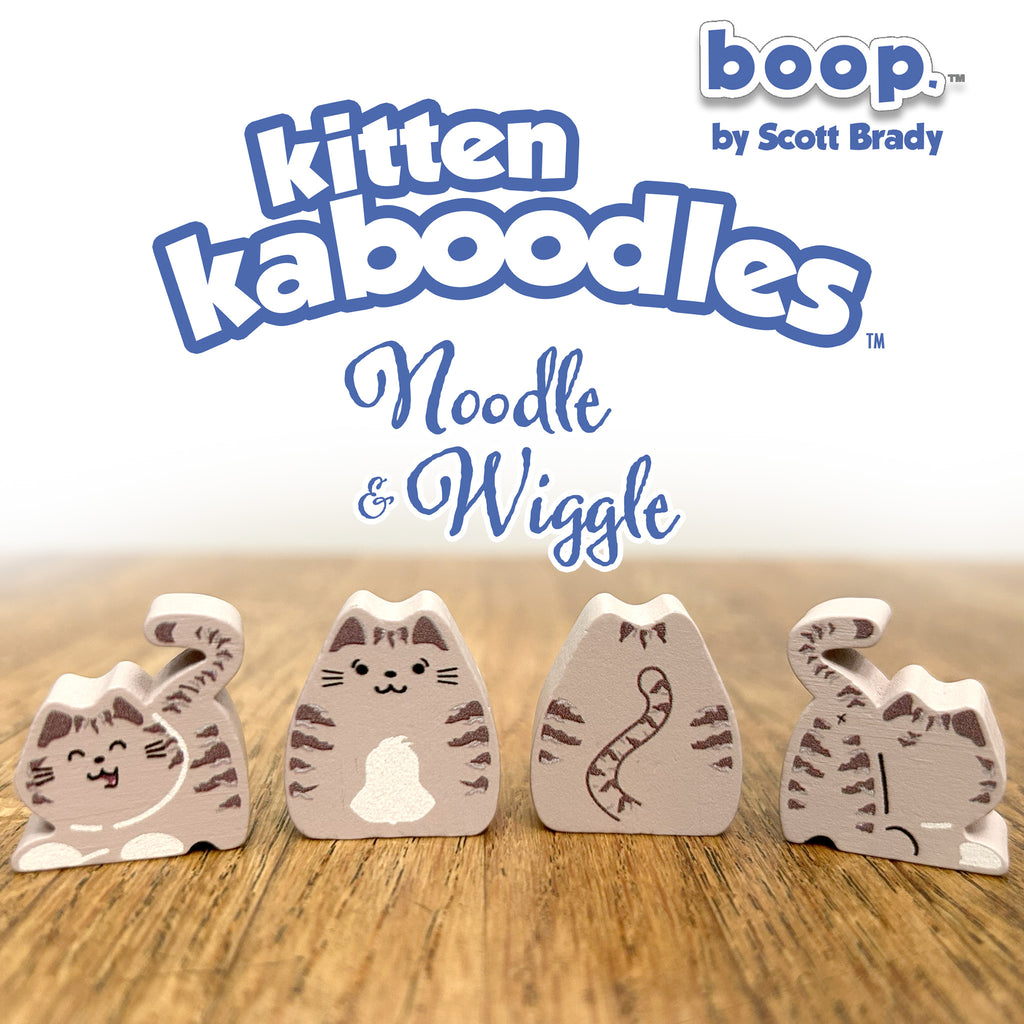 Kitten kaboodles toy figures with 'boop by Scott Brady' branding on a wooden surface.