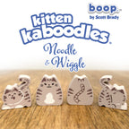 Kitten kaboodles toy figures with 'boop by Scott Brady' branding on a wooden surface.