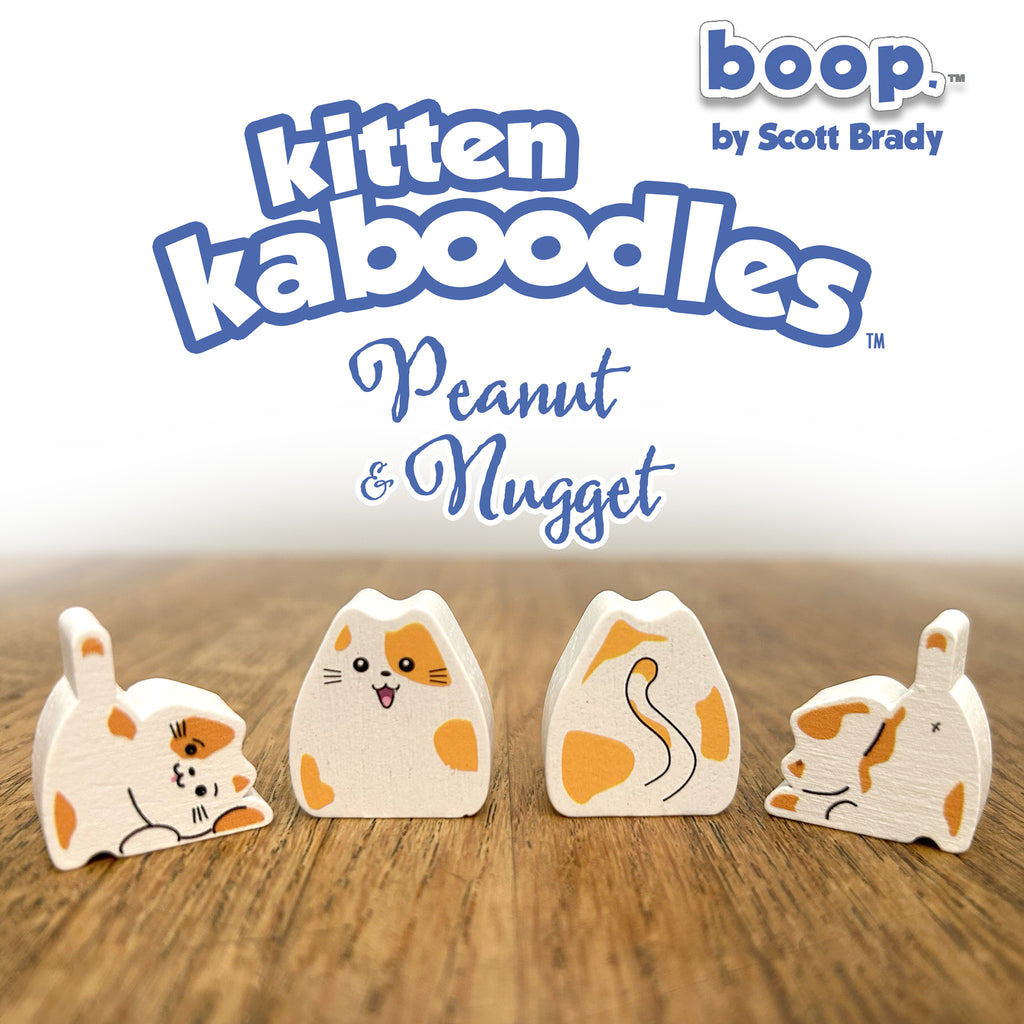 Wooden toy figures of a cat with 'boop' branding on a wooden surface.