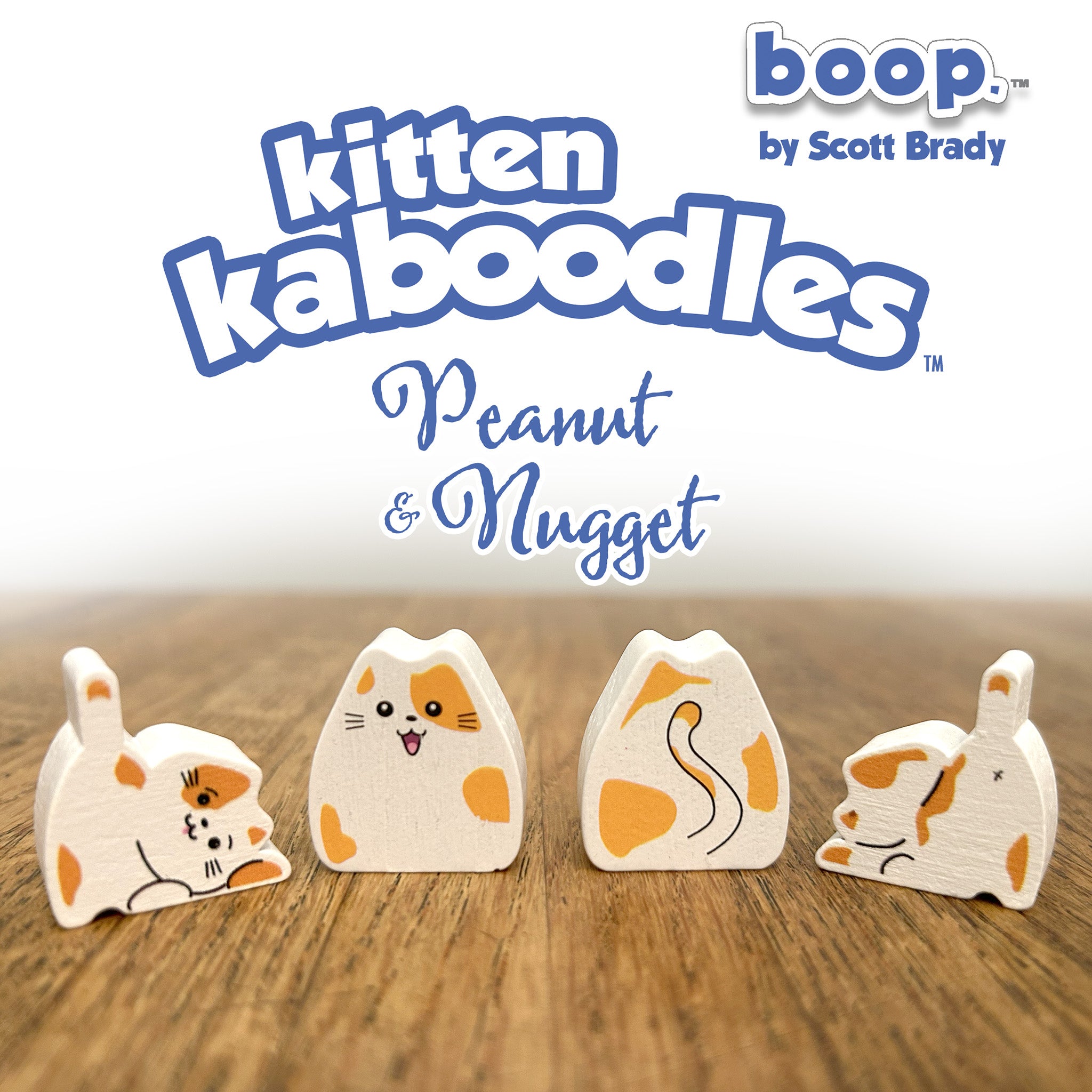 Wooden toy figures of a cat with 'boop' branding on a wooden surface.