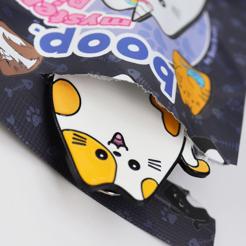 Cat pin in an open plastic package