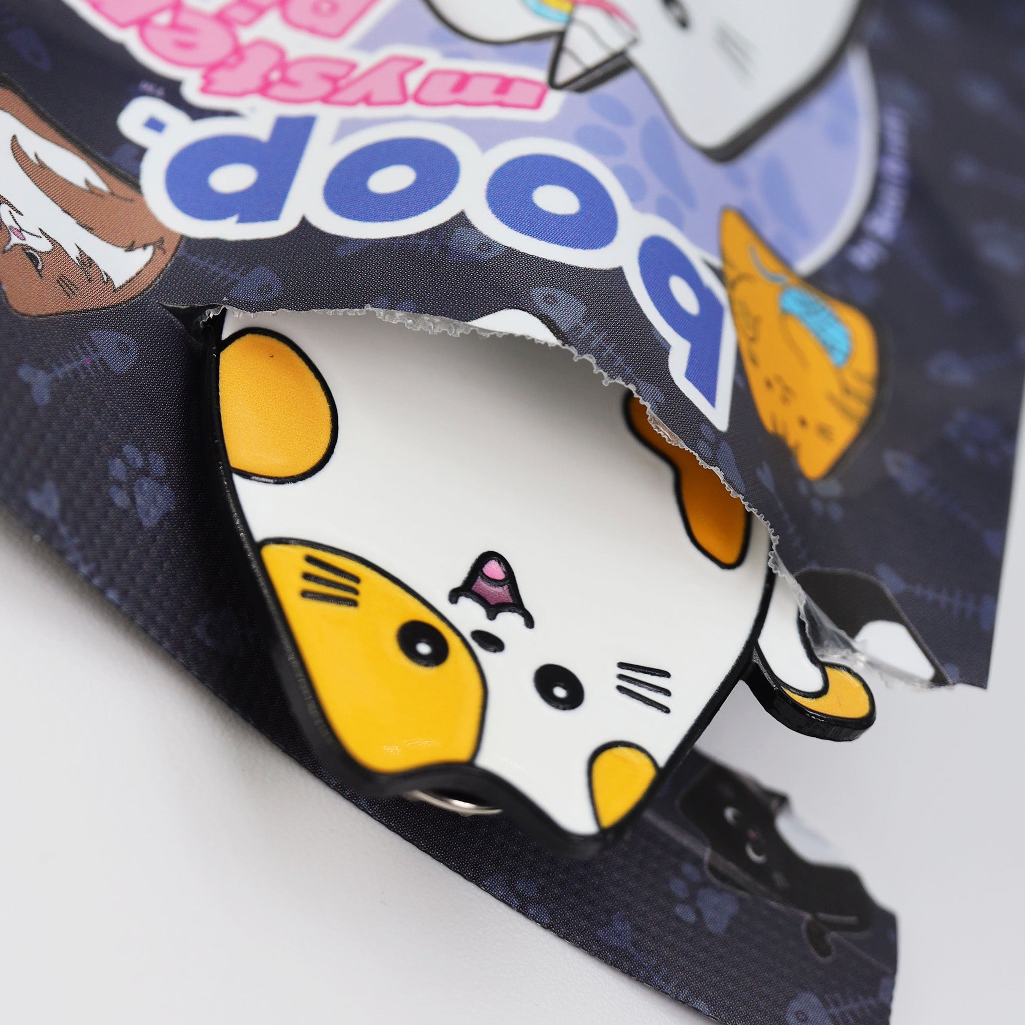Cat pin in an open plastic package