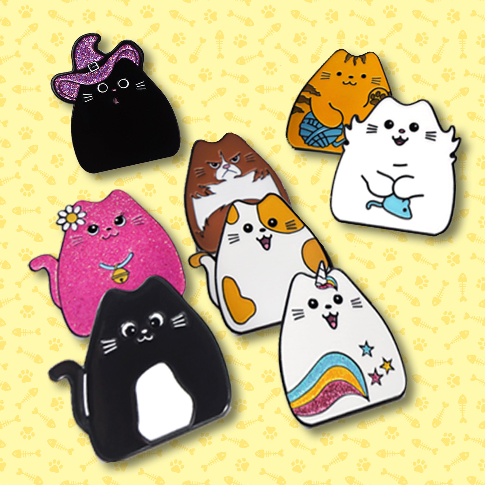 Set of colorful cat-shaped pins on a yellow background