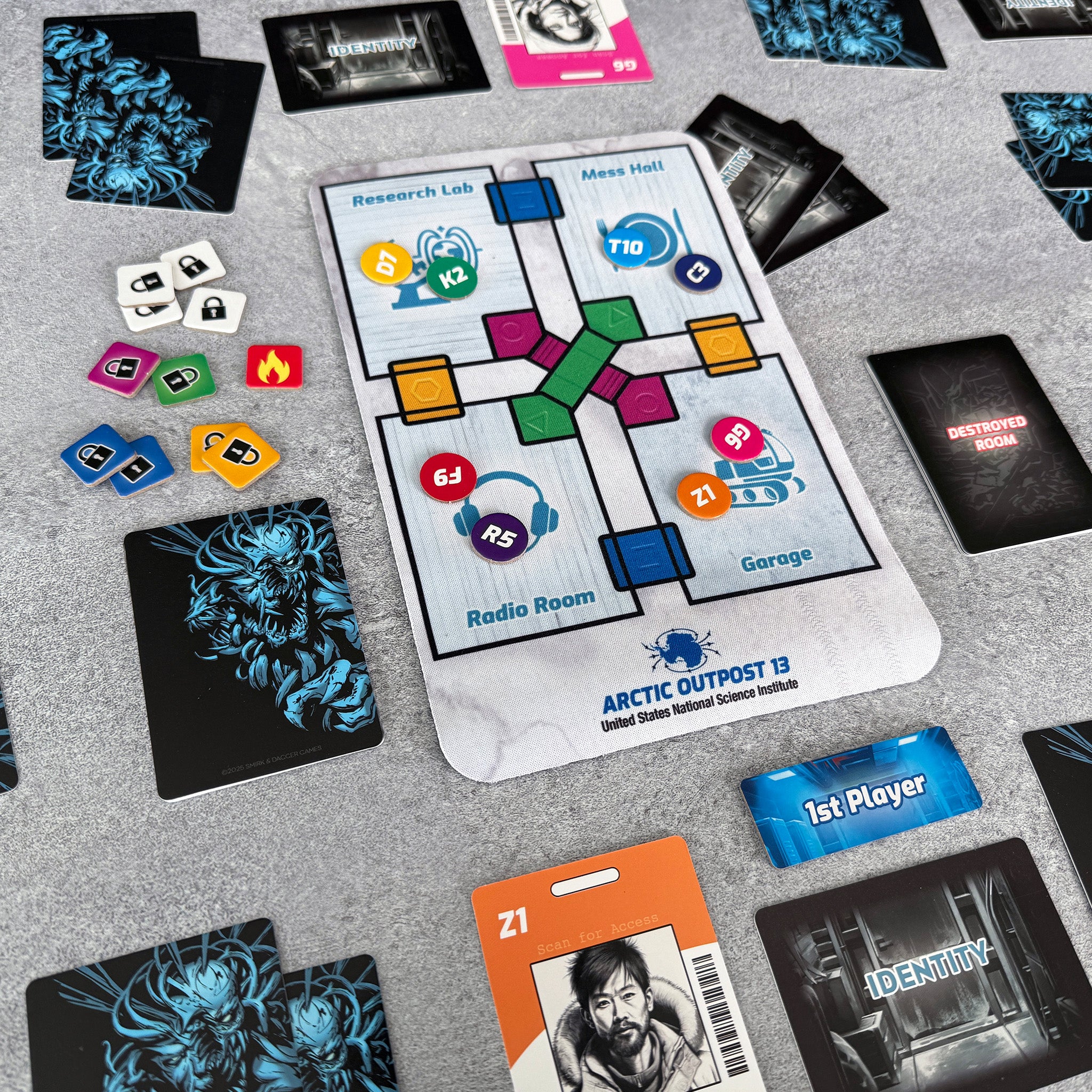 Board game components including cards and a map on a gray surface