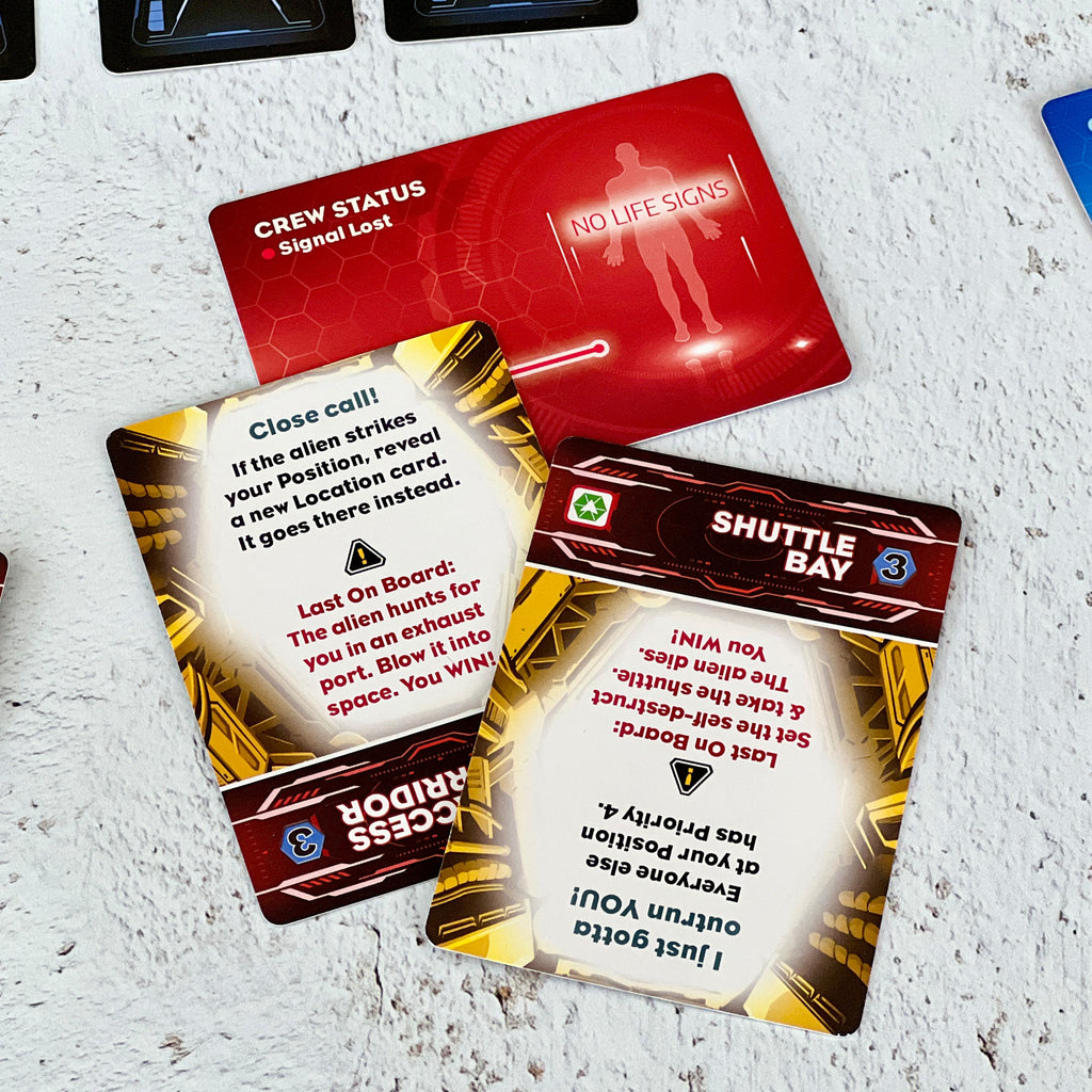 Close-up of game cards with text and graphics on a textured white surface