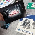 Card with 'The Horror' text held over a card featuring a person named Ferguson, Sara from Arctic Outpost 13.