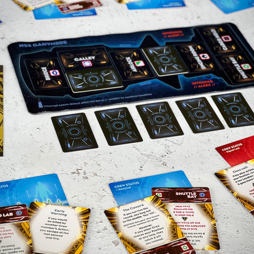 Board game components including cards and a game board on a textured surface