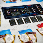 Board game components including cards and a game board on a textured surface