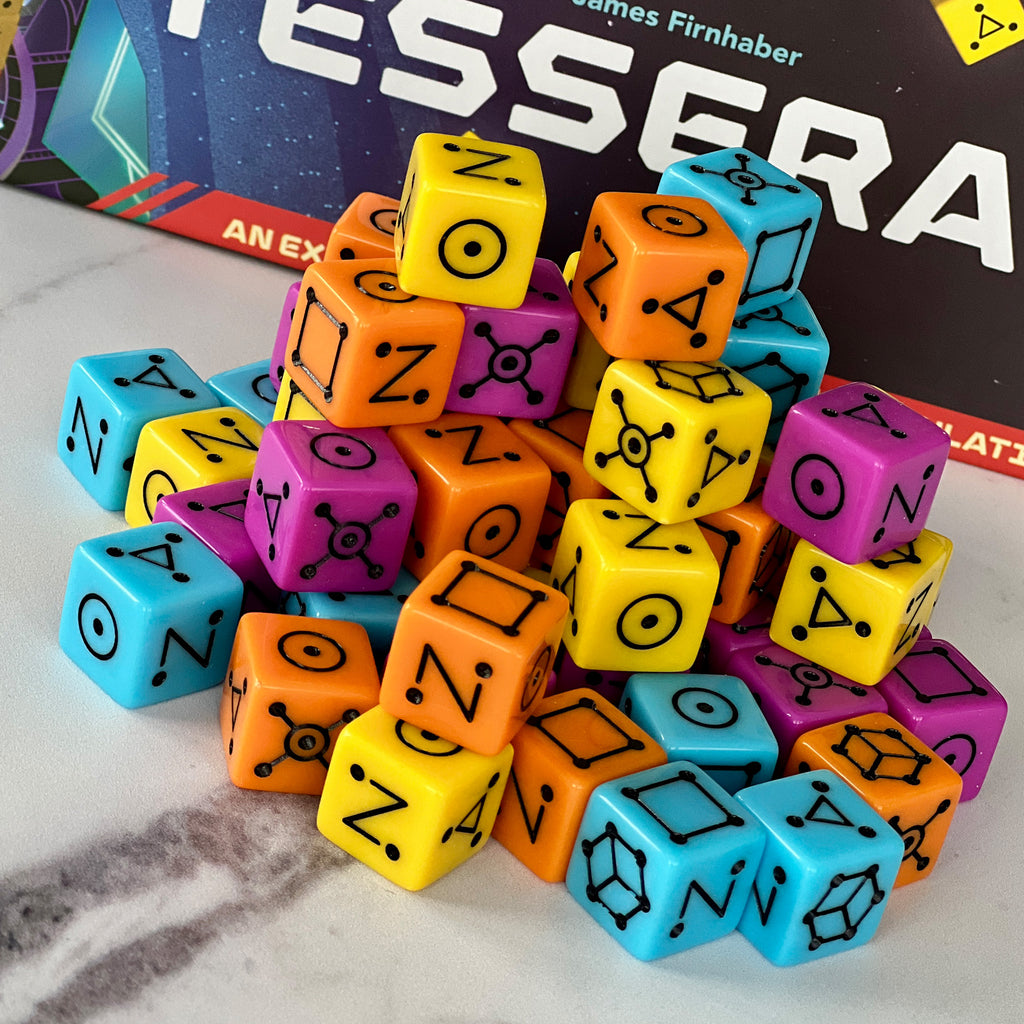 Colorful game dice with symbols on a surface, with 'Tesseract' branding in the background.